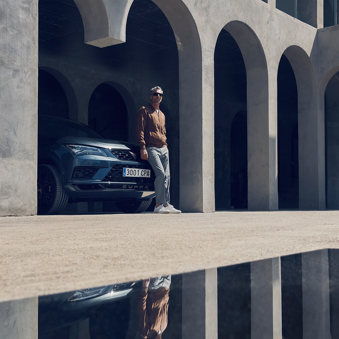 A man leaning on his CUPRA Ateca