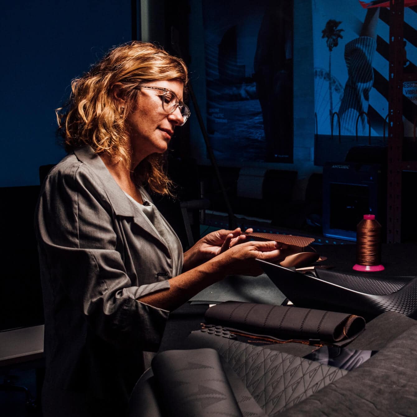  Francesca Sangallo, the creative director, working on a fabric in a dark workshop.