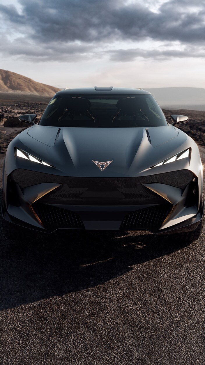 A close-up, eye-level shot shows the Cupra Formentor VZ5 and the Cupra Leon Sportstourer VZ5, parked inside a modern industrial garage.
